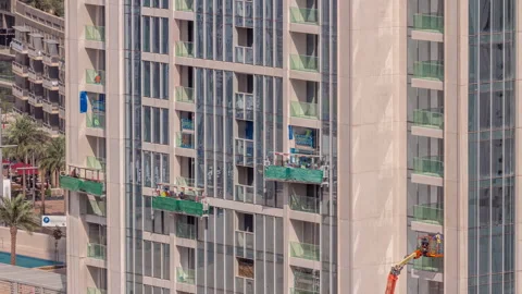 Suspended platform construction cradle hanging on building aerial timelapse Stock Footage 244256667
