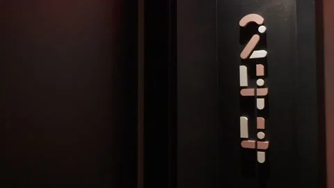 Suspenseful Atmosphere Featuring Softly Glowing Brass Numbers On Elevator In Video stock 323780342