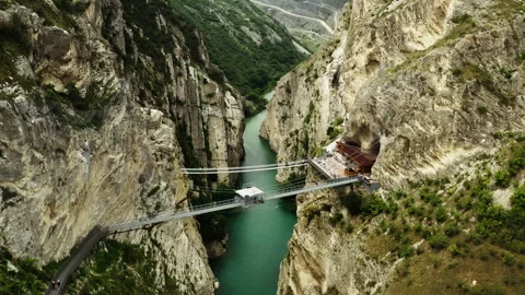A suspension bridge between two peaks of rocks. Stock Footage 260818010