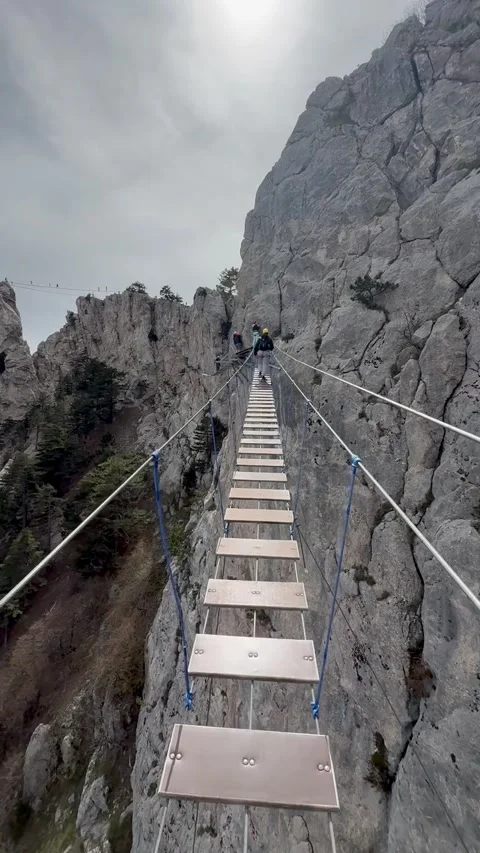 Suspension bridge on a cliff. Stock Footage 308498845