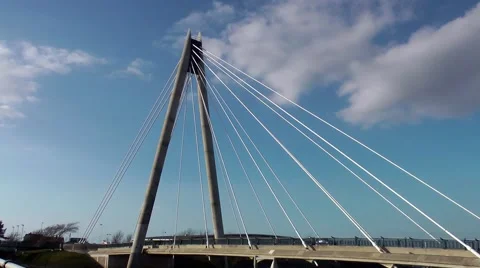 Suspension bridge deep blue sky moving traffic clouds Stock Footage 48679802