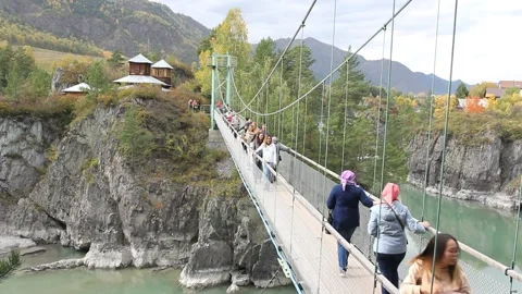 Suspension bridge via Katun river. The only one way to the monastery of Patmos Stock Footage 139951386