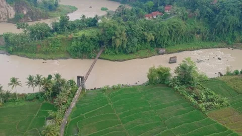 Suspension bridge over a flooded river. Stock Footage 277451759