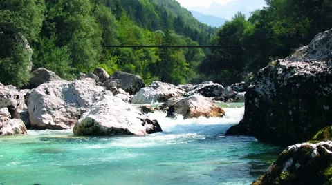 Suspension bridge over green river rapids Stock Footage 59100954