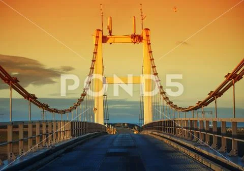 Suspension bridge over Jokulsa glacial river near Jokulsarlon Glacial lagoon Stock Photos