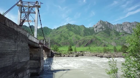 Suspension bridge over Katun river in Altay, Russia. Stock-Footage 69773679