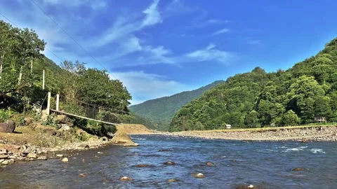 Suspension Bridge over a mountain river. Time lapse video Stock Footage 132797785