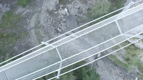 Suspension bridge over a river Stock Footage 138354691