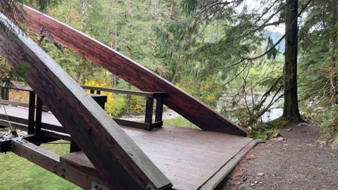 Suspension bridge over the river. Gateway wooden bridge. Video stock 220559250