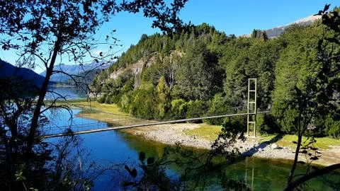 Suspension bridge over river Stock Photos