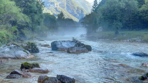 Suspension bridge over river rapids with haze - timelapse Stock Footage 56445406