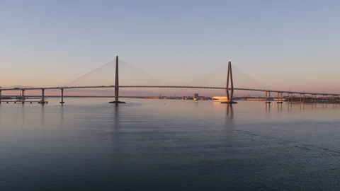 Suspension bridge over the river at sunset Stock Footage 96380922