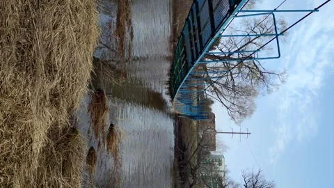 Suspension bridge over spring river Video stock 282814425