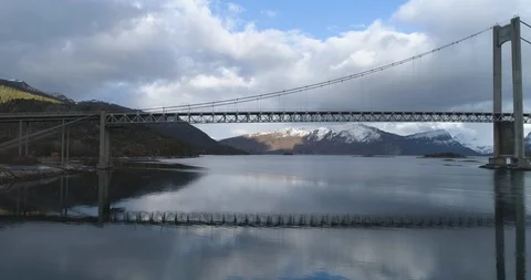 Suspension bridge passing over river on a sunny day Stock Footage 85838456