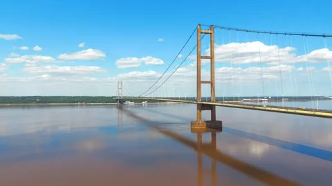 Suspension bridge spans wide, muddy river 스톡 동영상 343529570