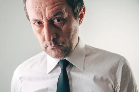 Suspicious businessman looking with distrustful expression Stock Photos