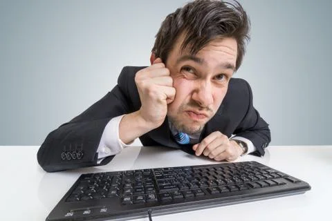 Suspicious businessman is looking at screen at work. Stock-Fotos