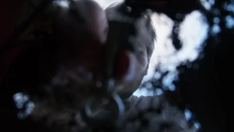 A suspicious man hides an old key in a secret place on the street, burying it Stock Footage 315356424