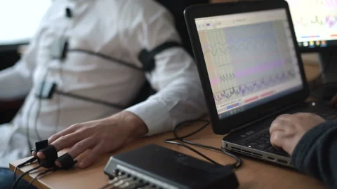 Suspicious man passes lie detector in the office. Asking questions Stock Footage 307308178