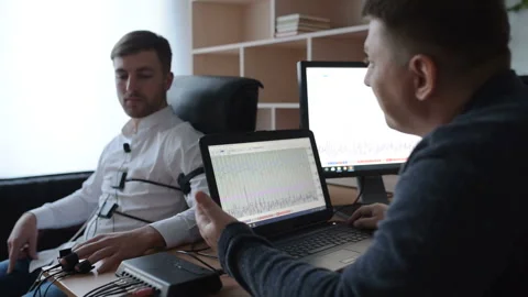 A suspicious man is passing a lie detector in the office. To ask questions Stock Footage 307308456