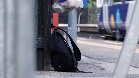 Suspicious rucksack left on railway platform Stock Footage 196185819