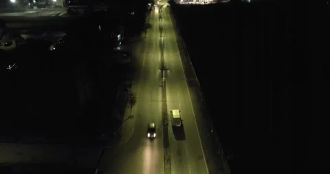 Suspicious traficking van drive on illuminated street at night 스톡 동영상 330101034
