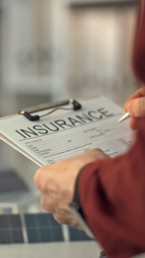 A sustainability expert reviews an insurance document at a workspace featuri Stock Footage 331531373