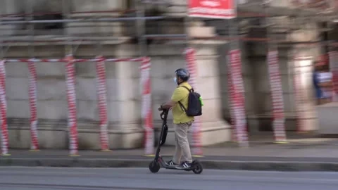 Sustainable mobility, a man goes to work with an electric scooter in Genoa Video stock 155397894
