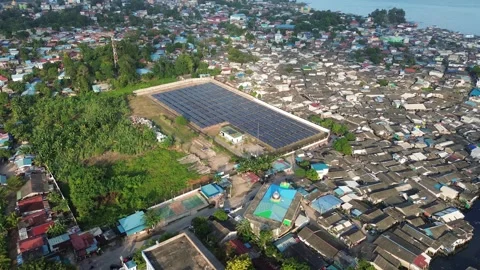 Sustainable Power Array in Coastal Urban Sprawl: An Aerial View of Solar En.. Stock Footage 335206915