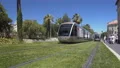 Sustainable public transport moving on green grass tracks, urban infrastructure 4k or 4k+ Resolution