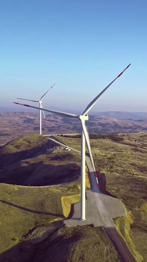 Sustainable source of energy, wind turbines, hilly scenery, vertical short video Stock Footage 283344914