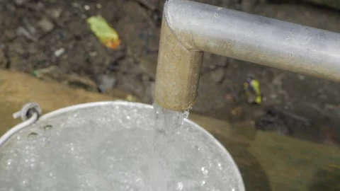 Sustained Flow from a Metal Tap - A Simple Elegance in Action Stock Footage 320930756