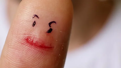 Сut finger with a sharp knife and drawn eyes. A funny safety reminder. Close-up  Stock Footage 266247996