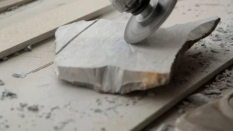 Сuts a tile to size with an electric grinde Stock Footage 129325475