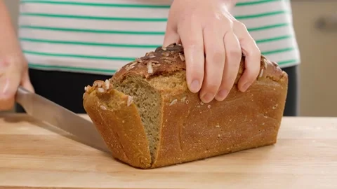 Сutting fresh homemade bread on the table, front view Stock Footage 155432587