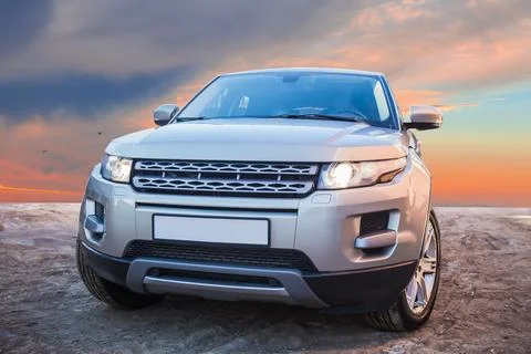 SUV on the background of a beautiful evening sky Stock Photos