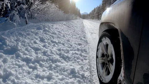 SUV car driving in deep snow on a Winter country road Stock Footage 124656475