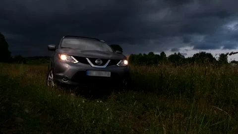 Suv car in the middle of the field overcast weather Stock Footage 246306187