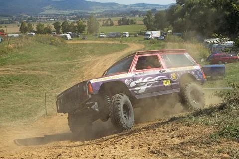 SUV car is passing through difficult terrain skid Stock Photos