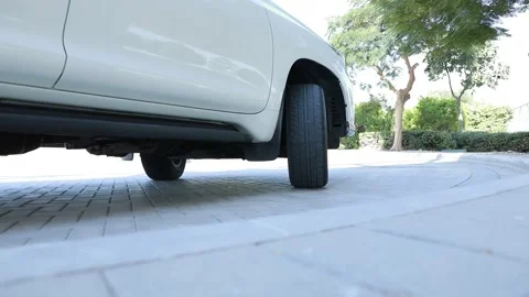 Suv Car rolling back and tire rotating in close up view in a white car Stock Footage 159592358