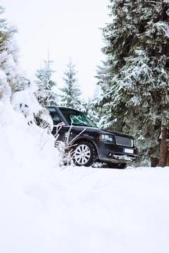 Suv car in snowed forest Stock Photos