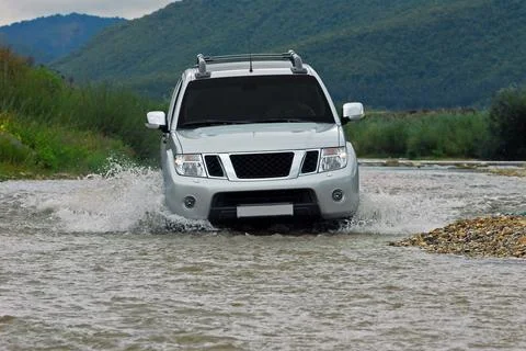 SUV crosses the river Fotos Stock