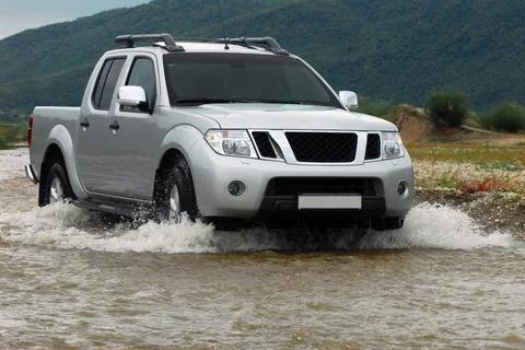 SUV crosses the river Фото