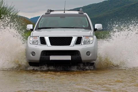 SUV crosses the river 写真素材