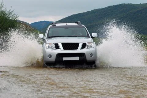 SUV crosses the river Fotos de archivo