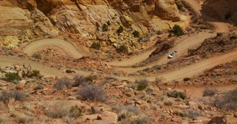 SUV descending Burr Trail Switchbacks into the colorful Strike Valley, Utah. Stock Footage 124024130