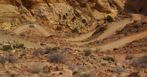 SUV  descending  Burr Trail Switchbacks into the colorful Strike Valley, Utah. Stock Footage 124026843