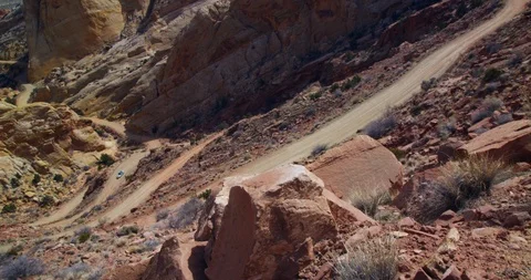 SUV descending  Burr Trail Switchbacks into the colorful Strike Valley, Utah. Stock Footage 124043898