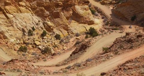 SUV descending Burr Trail Switchbacks into the colorful Strike Valley, Utah. Stock Footage 124044446