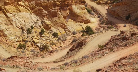 SUV  descending Burr Trail Switchbacks into the colorful Strike Valley, Utah. Stock Footage 124044852